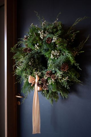 Fresh Christmas wreath with pine cones by Philippa Craddock