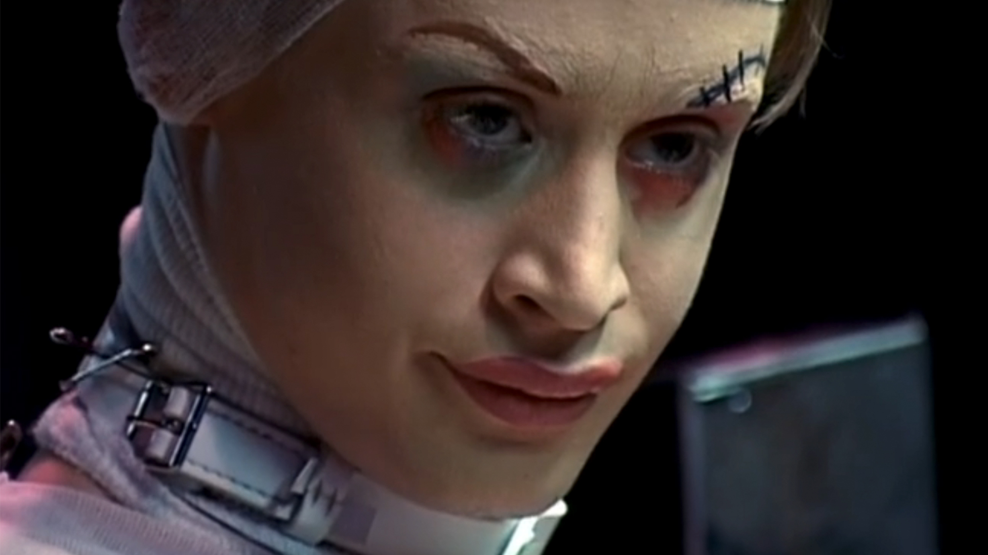 An extreme close up of Macaulay Culkin looking disappointed and wearing make up in Party Monster.