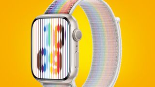 An Apple Watch with a Pride Edition band on a yellow background