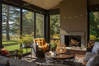 an indoor outdoor sunroom at a lake house