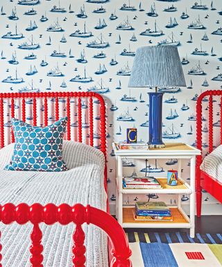 bedroom with red bobbin beds, boat wallpaper and colorful ru