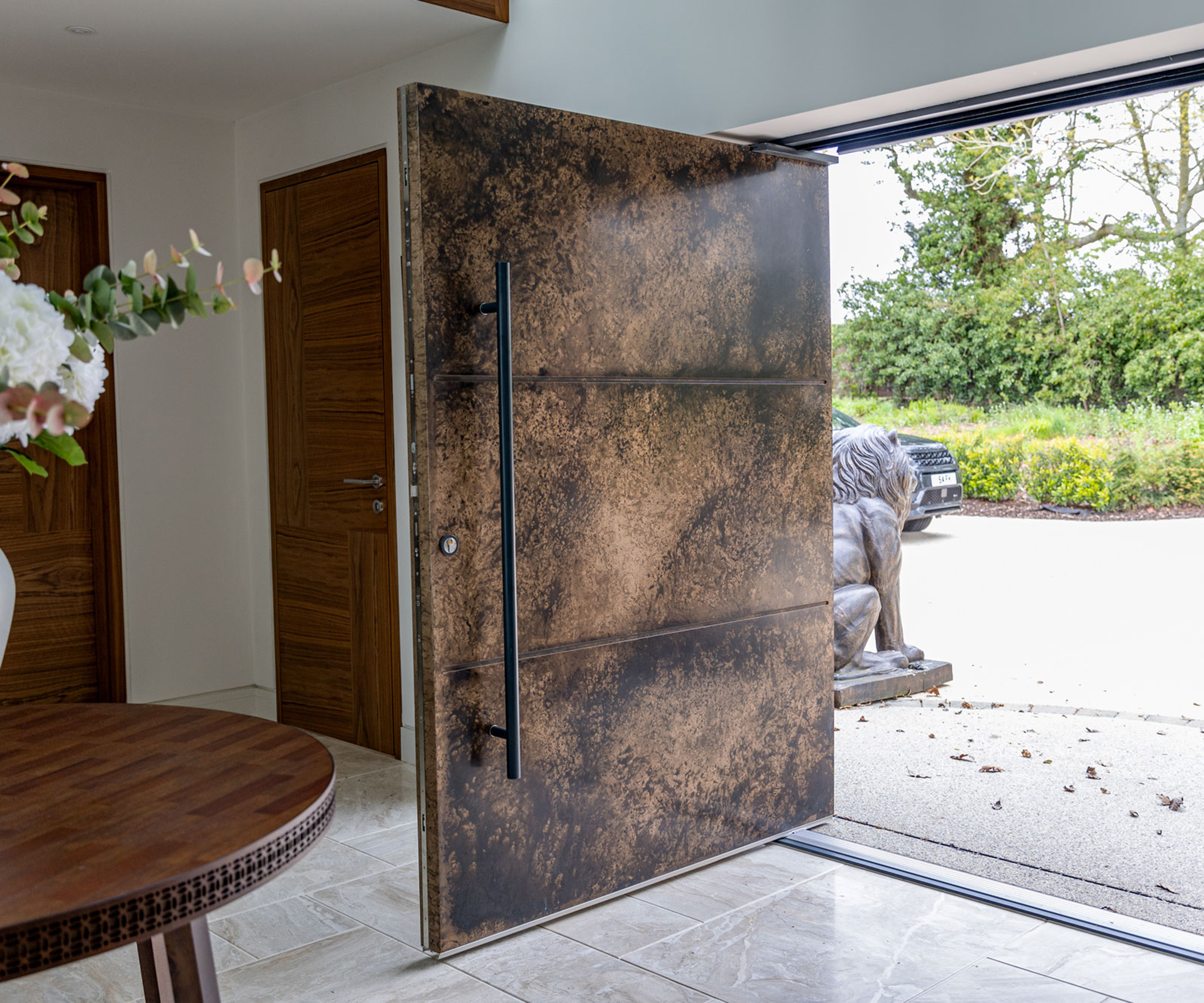 A large pivot door with artistic grain effect