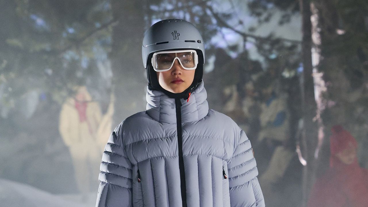 model wearing ski helmet, skin goggles and blue ski jacket on the moncler runway - ski skincare routine