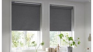 Two IKEA FYRTUR smart blinds closed halfway on windows