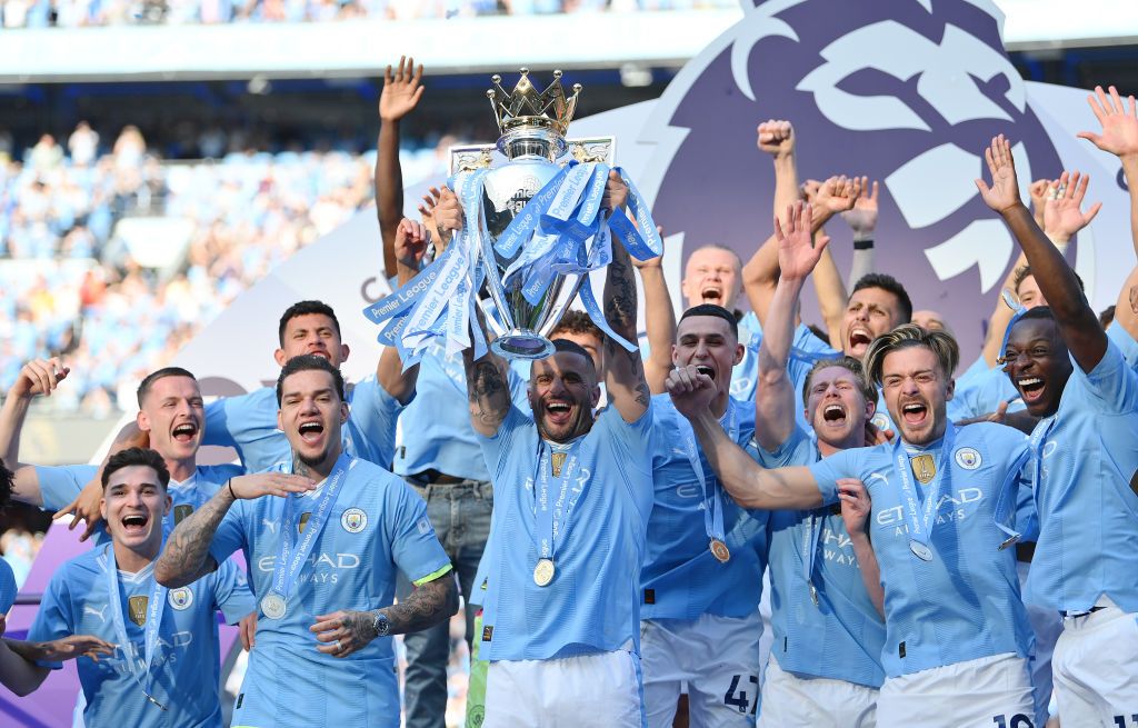 Kyle Walker of Manchester City lifts the Premier League Trophy at the end of the 2023/24 season