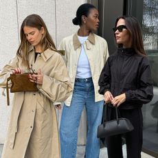 Influencer Marilyn wears a light beige barn coat and straight-leg jeans with black loafers. Influencer Clara wears a long trench coat and trousers. Influencer Johanna wears a black funnel-neck jacket and black trousers with a black East and West bag. 