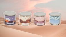 Four new Yankee Candle scents from the Under the Desert Sun collection on a desert sunset background