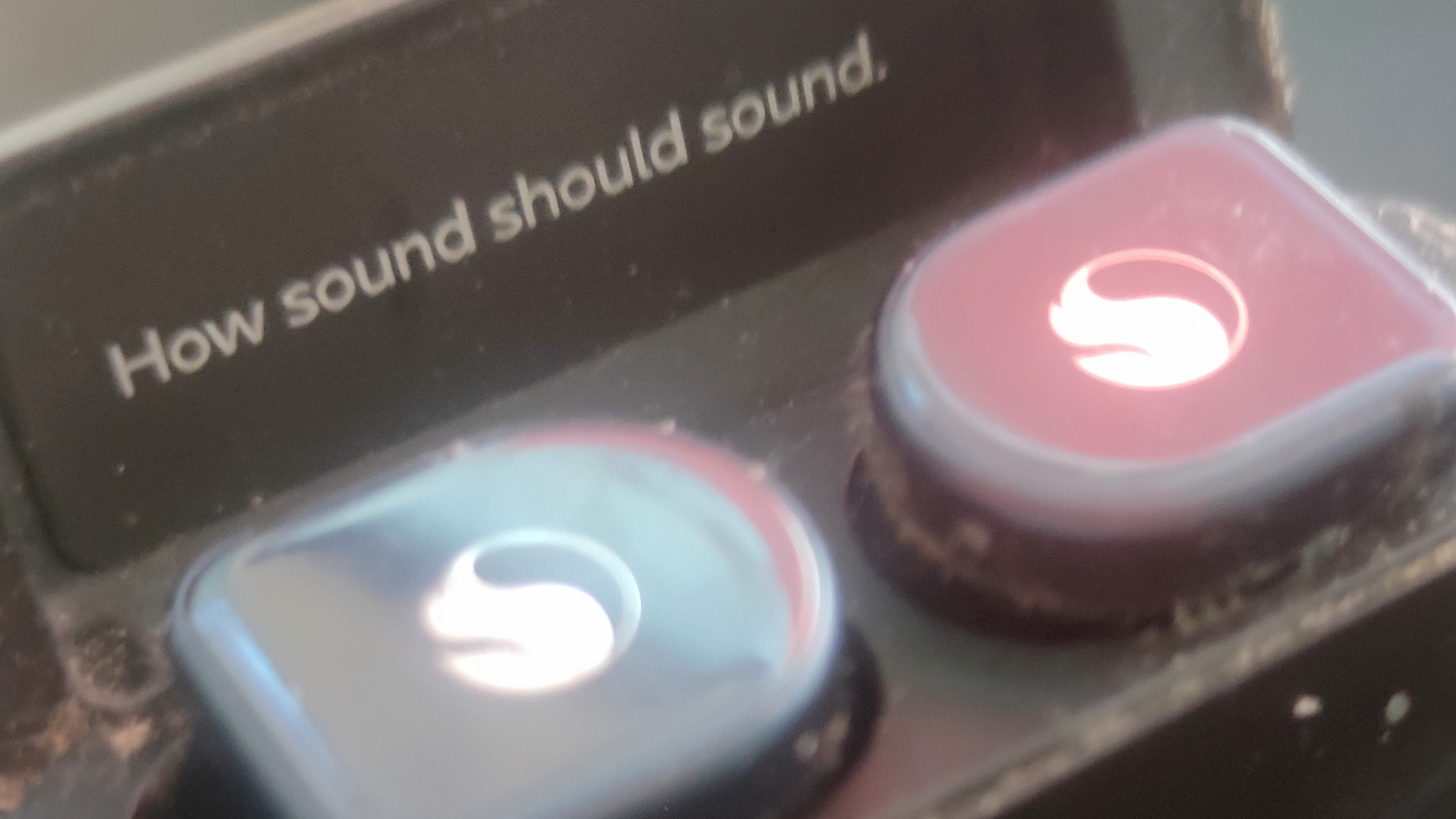 The Snapdragon Sound logo and tagline on earbuds.