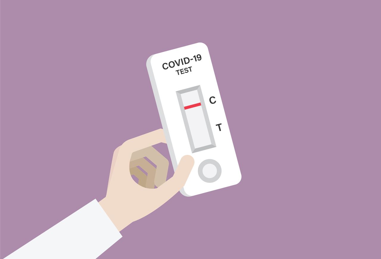 A drawing of a hand holding a COVID-19 test.