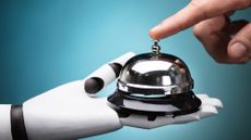A robotic hand holds a service bell