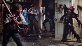 James Karen holding a bat in The Return of the Living Dead