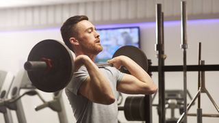 How long does it take to build muscle? Image shows man lifting barbell