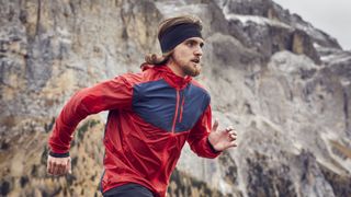 A man trail running wearing a headband