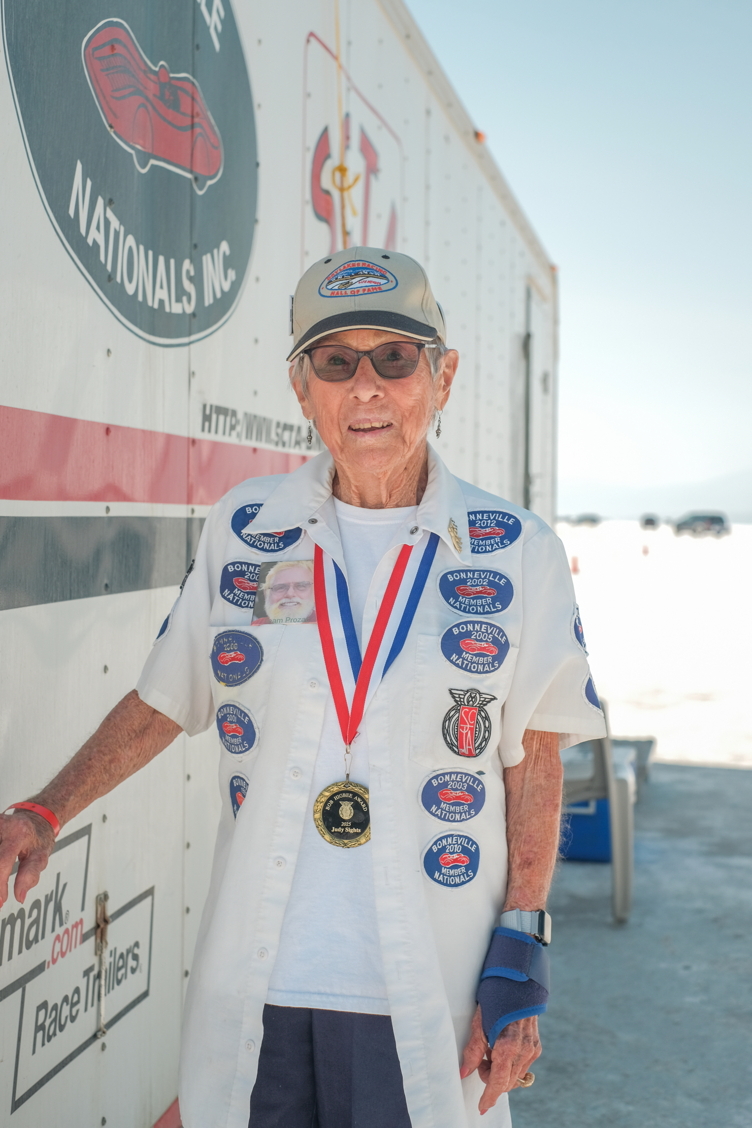 Judy Sights, with patches on her shirt and a medal around her neck