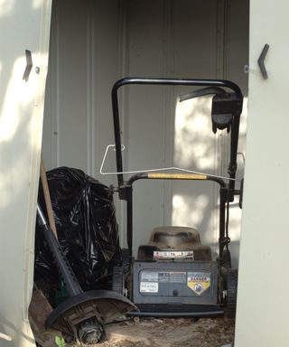 Electric lawnmower stored in a shed for winter