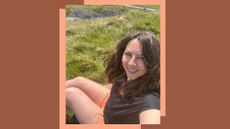 Susan Griffin wearing the hiking shorts for women from Patagonia, sitting on grassy hill in the Pennines