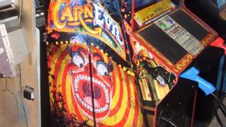 The demonic gate to CarnEvil, displayed prominently on the side of the cabinet design (this one has custom pistols in place of shotguns).