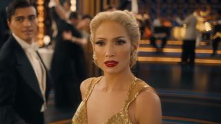 Jennifer Lopez with platinum blonde hair in yellow dress in Kiss of the Spider Woman