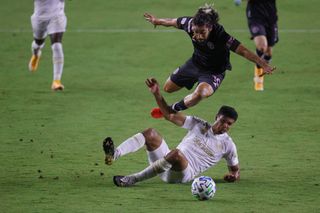 Rodolfo Pizarro of Inter Miami CF tries to avoid the slide tackle by Atlanta United's Miles Robinson on Sept. 9.