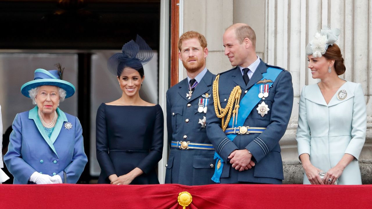 Queen Elizabeth II, Meghan, Duchess of Sussex, Prince Harry, Duke of Sussex, Prince William, Duke of Cambridge and Catherine, Duchess of Cambridge watch a flypast to mark the centenary of the Royal Air Force from the balcony of Buckingham Palace on July 10, 2018 in London, England.