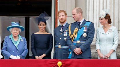 Queen Elizabeth II, Meghan, Duchess of Sussex, Prince Harry, Duke of Sussex, Prince William, Duke of Cambridge and Catherine, Duchess of Cambridge watch a flypast to mark the centenary of the Royal Air Force from the balcony of Buckingham Palace on July 10, 2018 in London, England.
