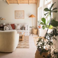 A neutral living room with vintage and textural pieces of furniture