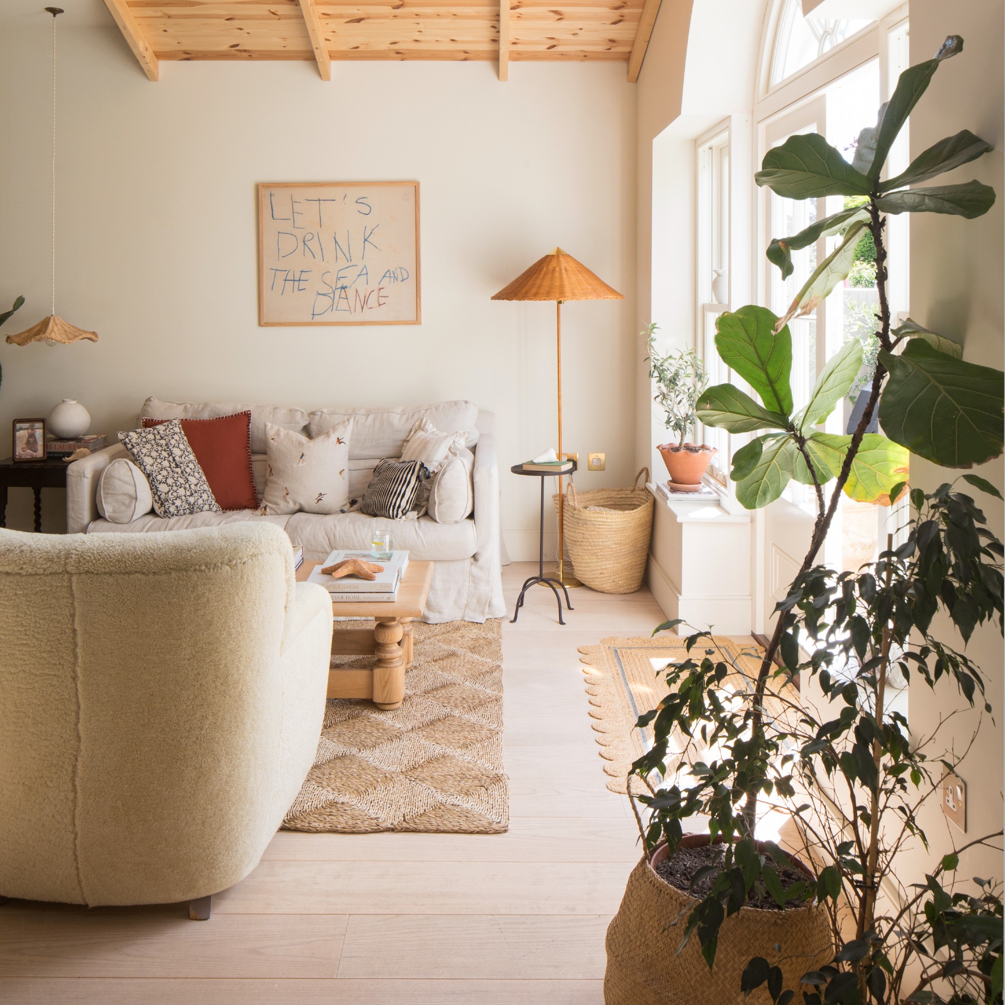 A neutral living room with vintage and textural pieces of furniture
