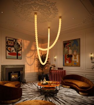 A living room with ceiling moulding and a long light flowing from it