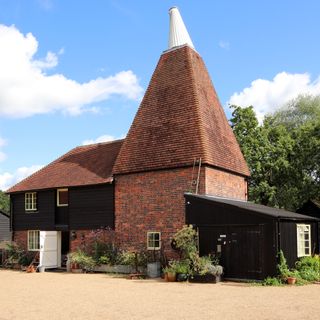 oast house with brick wall and potted plant