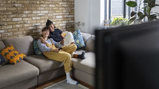 Couple watching TV on an ultra-HD blu-ray player