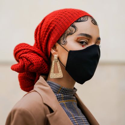 woman with red scarf and black face mask