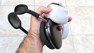 AirPods Max vs. Bose QuietComfort Ultra headphones held together in reviewer's hand