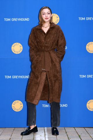 Gigi Hadid wearing a brown coat on the red carpet