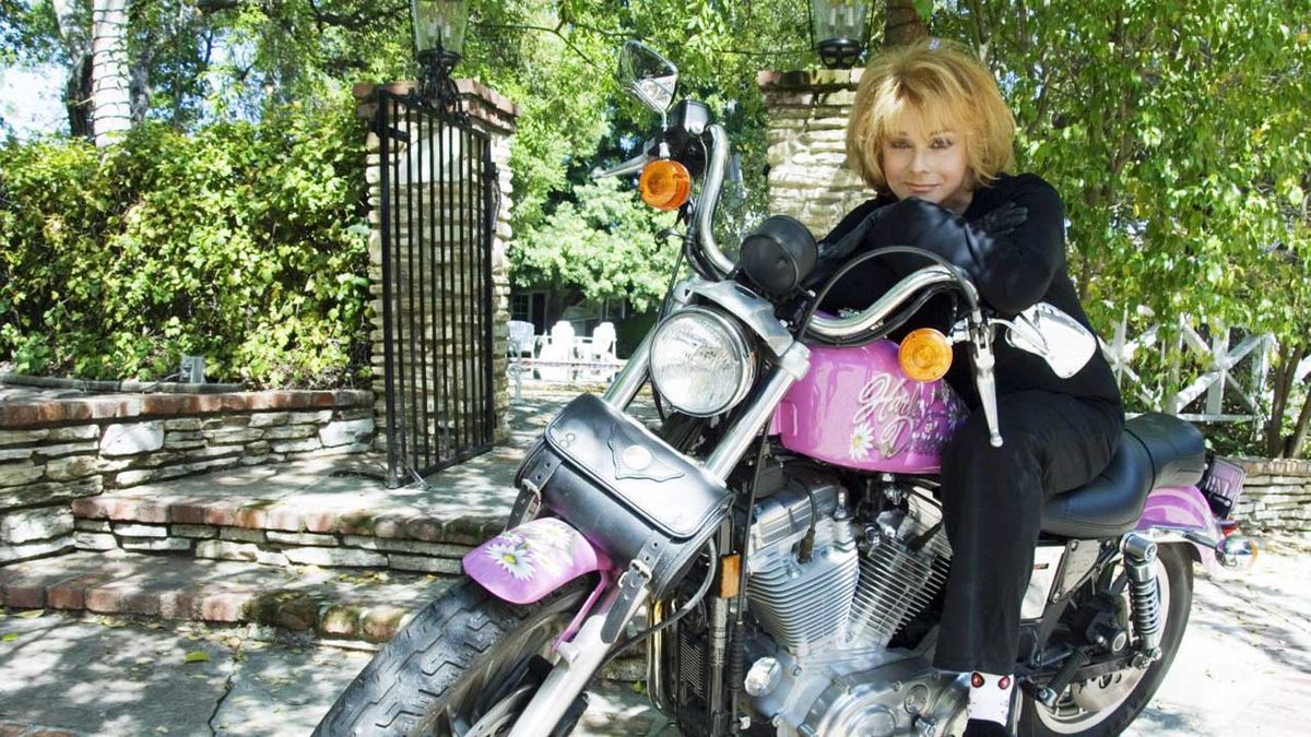 Ann-Margaret straddling a Harley Davidson