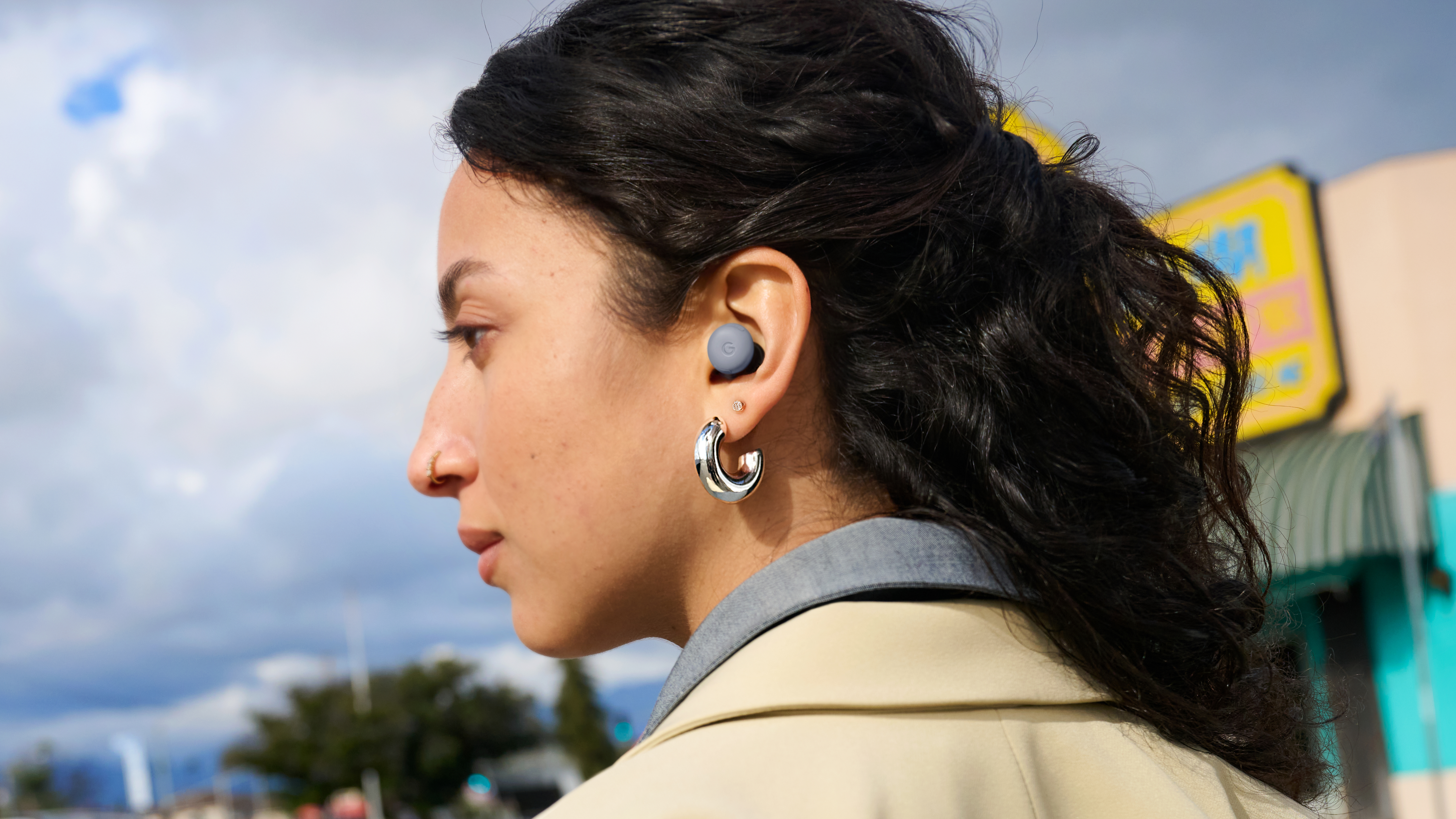 A woman wearing the Google Pixel Buds Pro 2