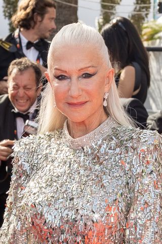 Actress Helen Mirren is pictured with long hair in a half-up half-down hairstyle at the screening of "Mother And Son (Un Petit Frere)" during the 75th annual Cannes film festival at Palais des Festivals on May 27, 2022 in Cannes, France.