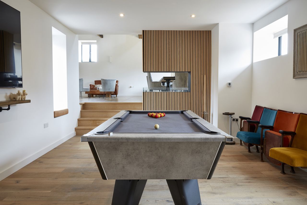modern games room with pool table and fire