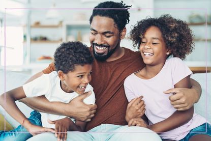 A father hugging two children either side of him