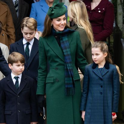 Prince William, Prince George, Prince Louis, Kate Middleton, Princess Charlotte wearing navy and green coats outside church on Christmas Day