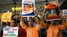 Protesters hold posters about the arrest of Bangladeshi Hindu monkhinmoy Krishna Das and demand his immediate release