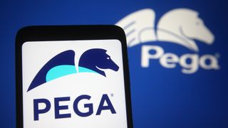 The Pegasystems logo on a phone and in the background of the shot.