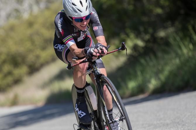 Flavia Oliveira slid from second to fourth in GC after after finishing 48 seconds off the winner in the stage three time trial.