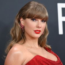 Taylor Swift wearing a red dress at the Grammy Awards.