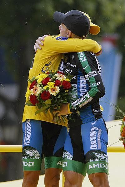 Team-mates on the podium Leipheimer and Contador do a group hug.