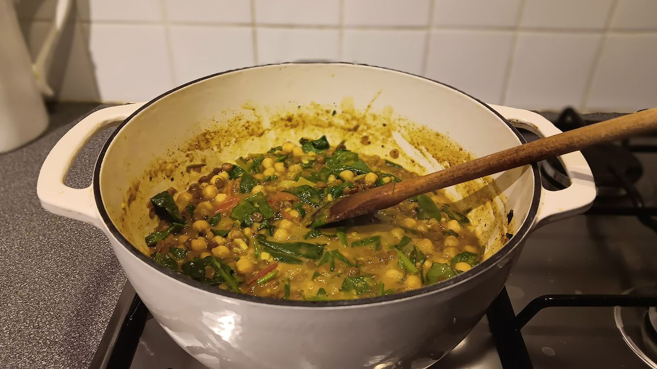 Curry cooking on the stovetop in a Dutch oven