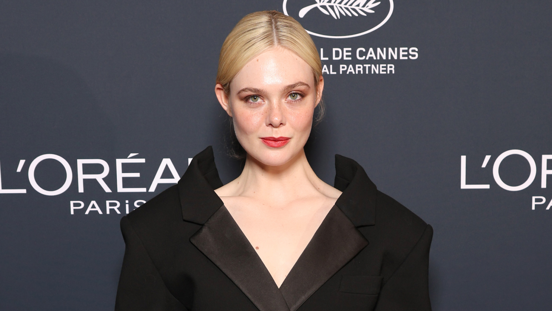 Elle Fanning wears a black Givenchy skirt suit on the red carpet for the L'Oreal Lights on Women's Worth Award at the 78th Cannes film festival on May 23, 2025