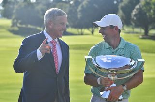 Jay Monahan and Rory Mcilroy chat whilst Rory holds the FedEx Cup