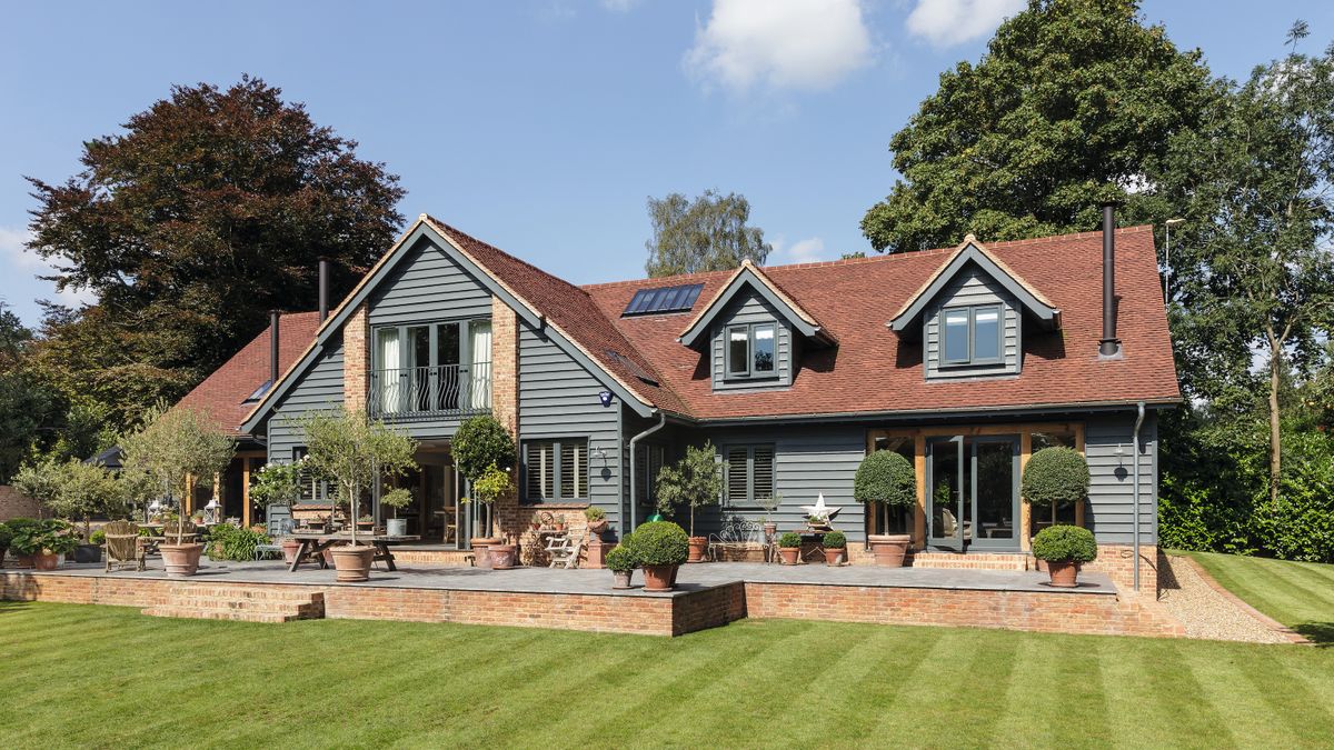 blue timber cladding on exterior of barn style self build