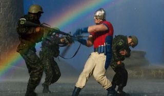 Peacemaker fights troops in the middle of a rainbow in The Suicide Squad.