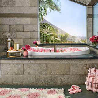 bathroom with flower vase and white tub